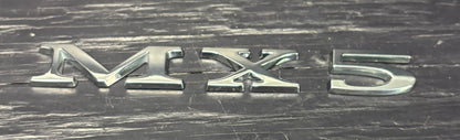 MX5 logo on a metallic surface