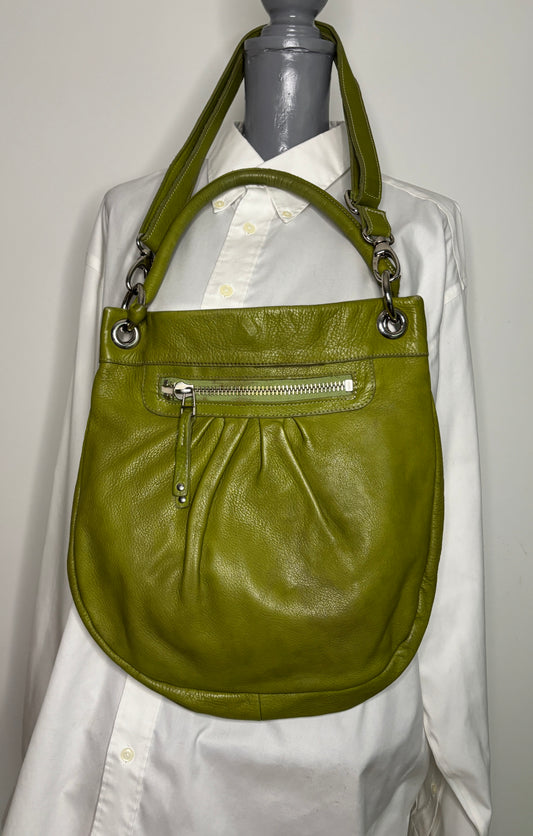 Green handbag on a mannequin with a white shirt