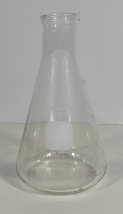 A clear glass Erlenmeyer flask with a conical shape and a short neck, shown on a plain light background.