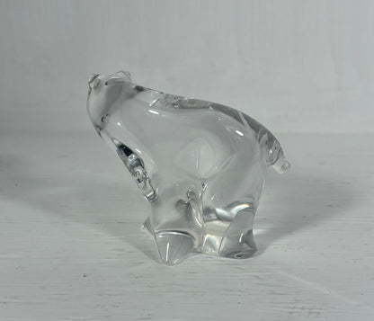 Clear glass bear figurine on a light wooden surface