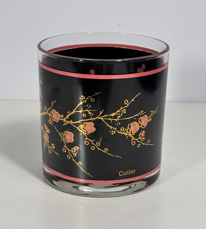 Glass tumbler with black interior, floral design, and 'Cutler' branding on a white background