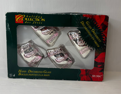 Box of hand-decorated glass Christmas ornaments with 'Holiday Collection' branding.