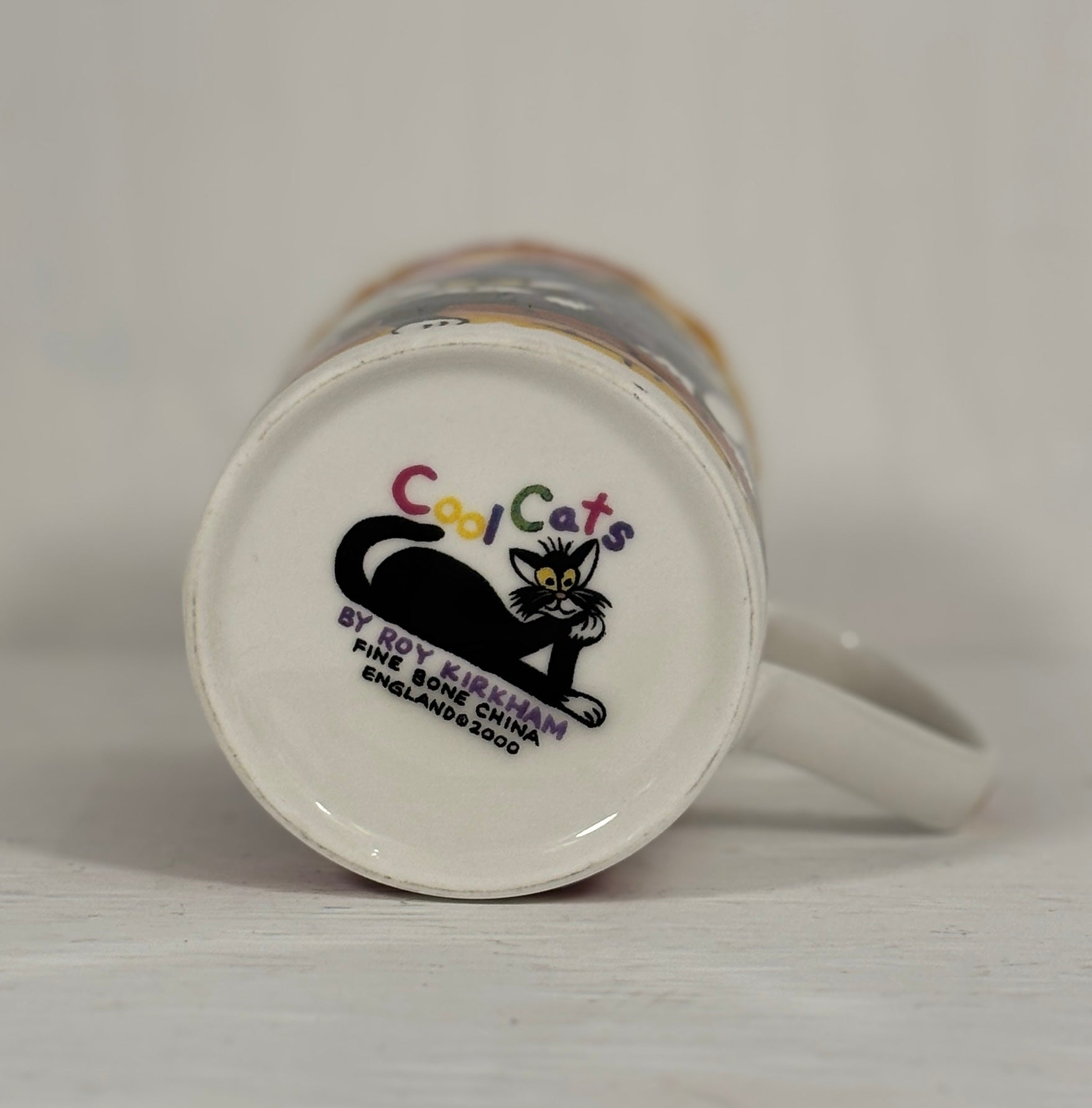 White mug with 'Cool Cats' logo on a plain background