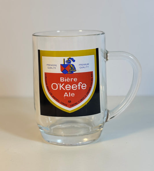 Clear glass mug with a 'Bière O'Keefe Ale' label on a white background