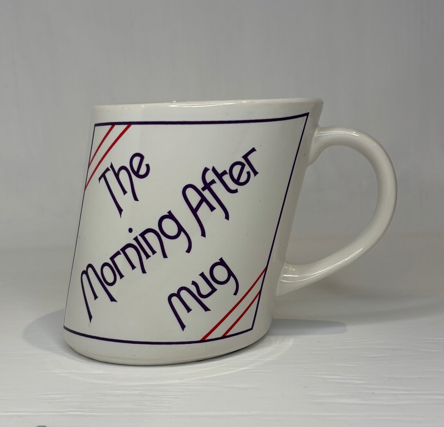 White mug with text 'The Morning After Mug' on a white background