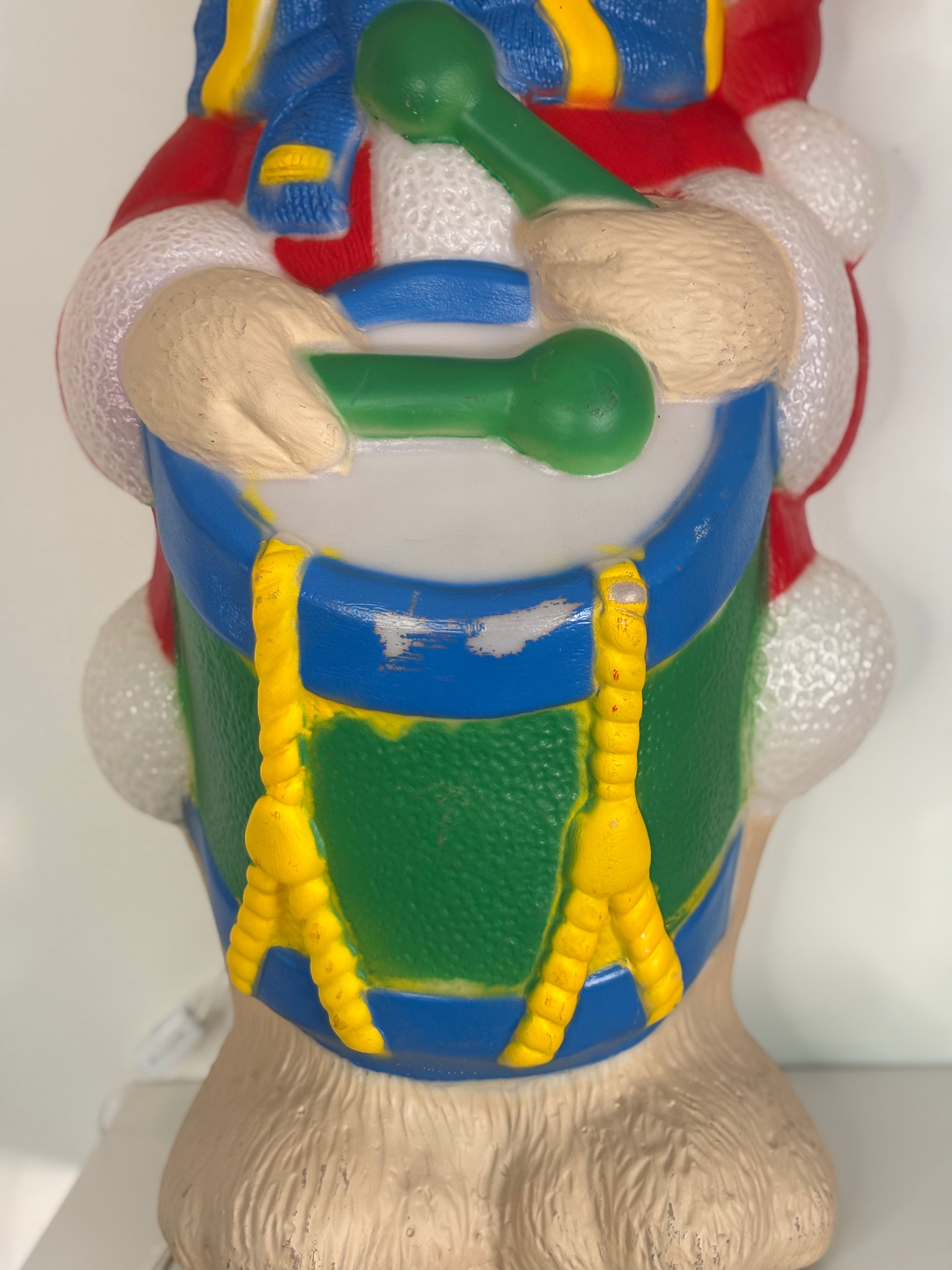 Colorful toy figure with a drum, on a white background