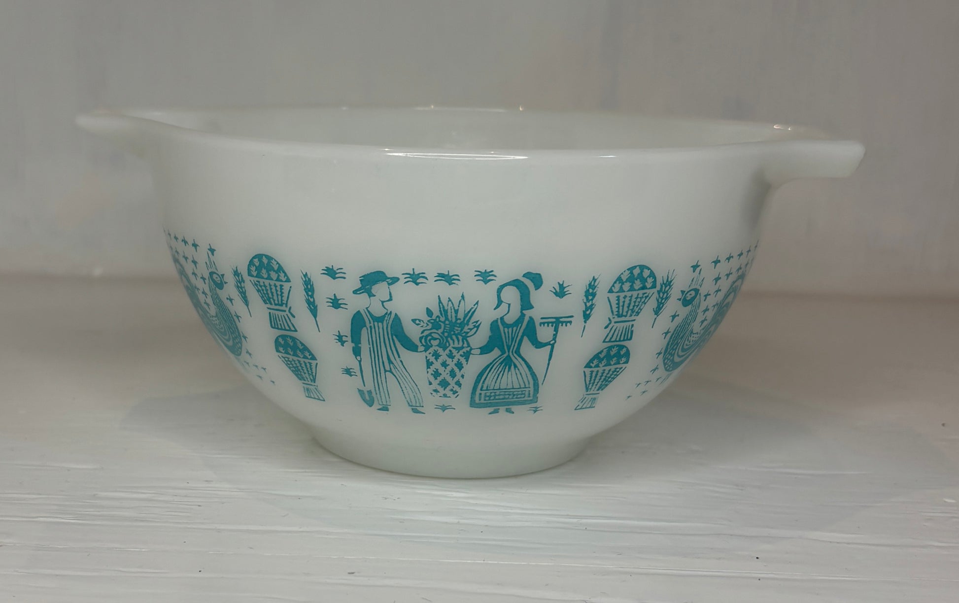 White mixing bowl with blue pattern on a white background