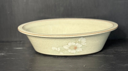 Decorative ceramic bowl with floral patterns on a dark surface