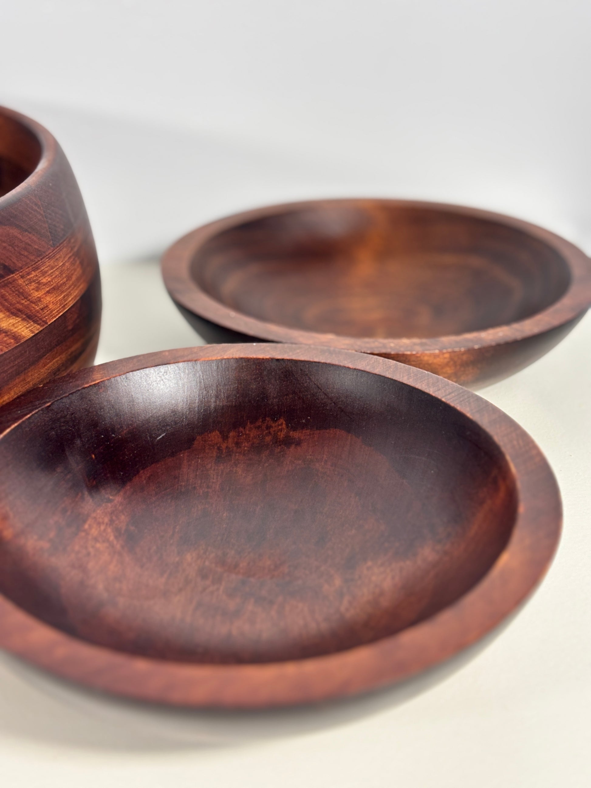 Three wooden bowls of different sizes on a white background