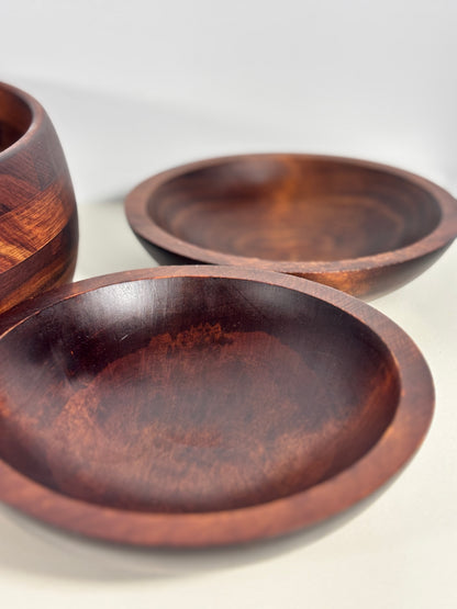 Three wooden bowls of different sizes on a white background