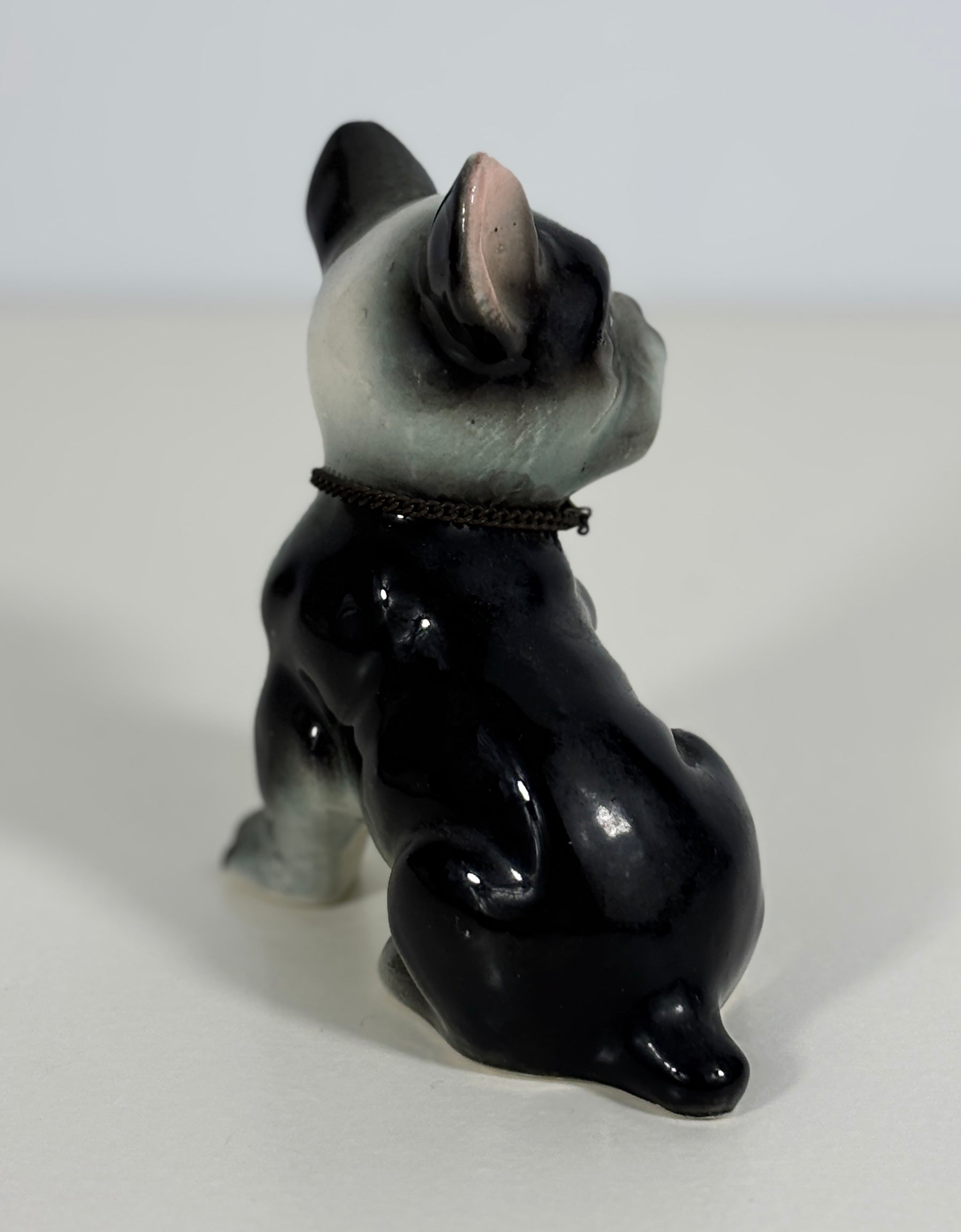 Black and gray ceramic dog figurine on a white background