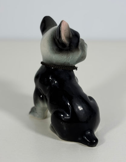 Black and gray ceramic dog figurine on a white background