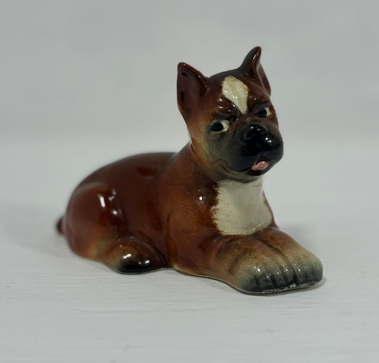 Small ceramic figurine of a dog on a white background