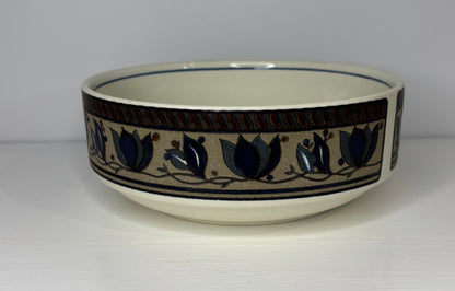 Ceramic bowl with decorative blue tulip pattern on a white background