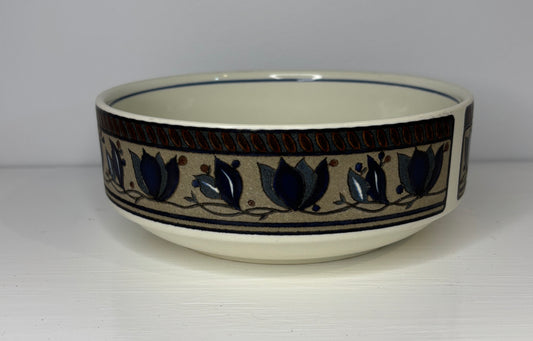 Ceramic bowl with decorative blue tulip pattern on a white background
