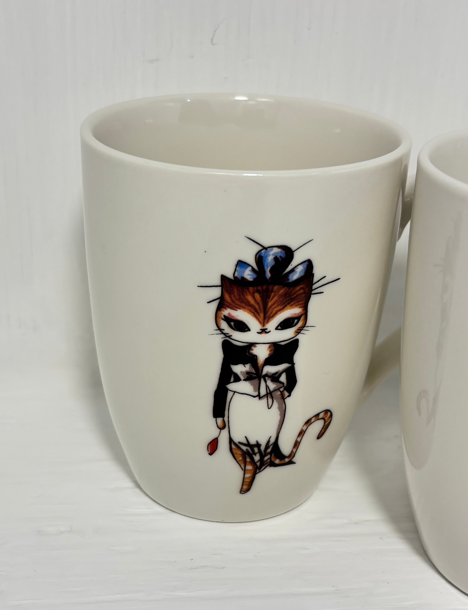 White mug with a cat illustration on a white background