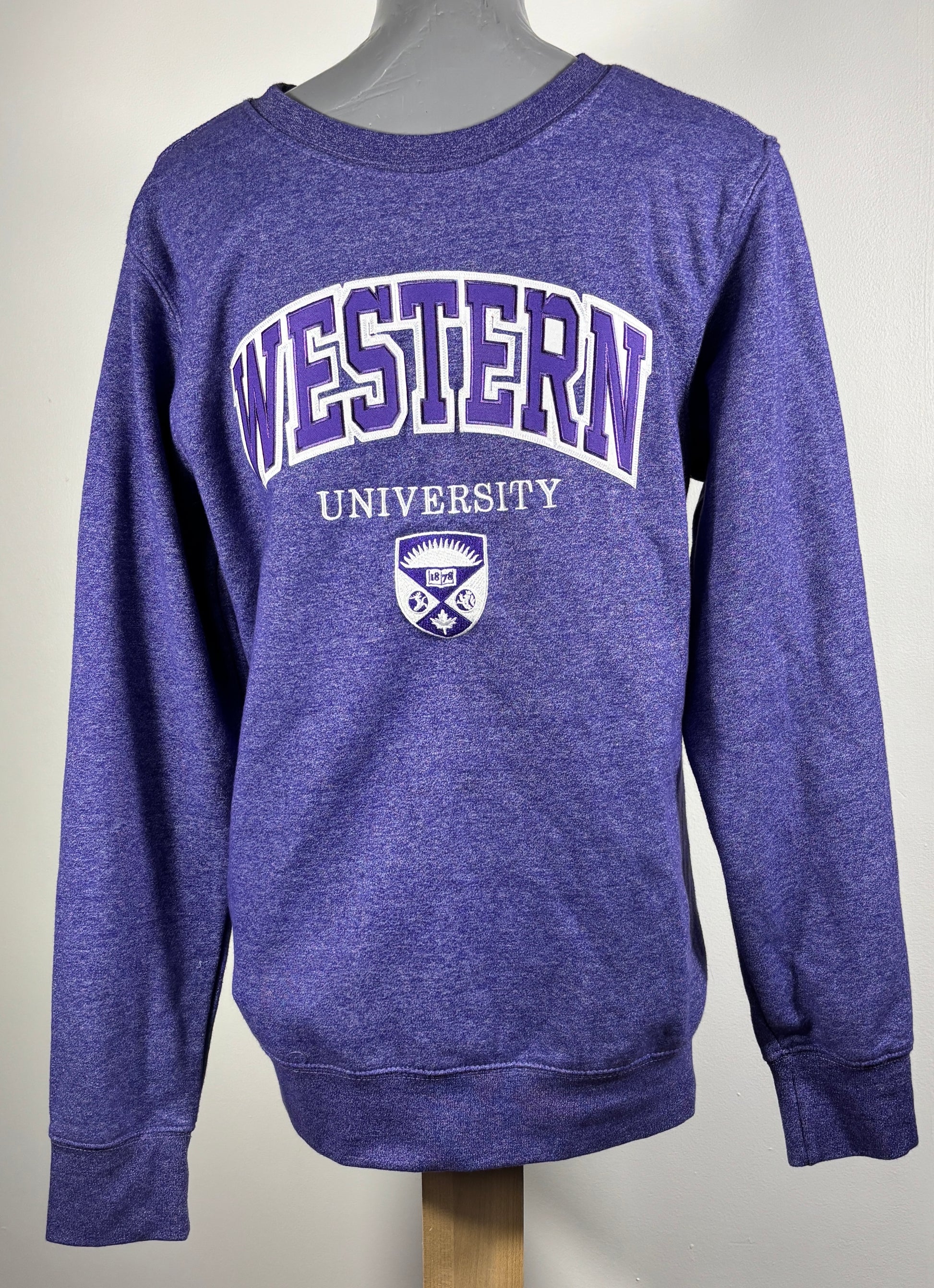 Purple sweatshirt with 'Western University' text and logo on a mannequin.