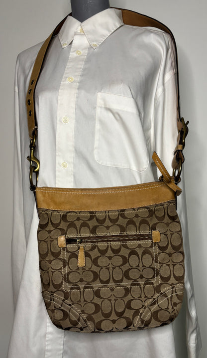 Coach crossbody bag with brown and beige pattern on a mannequin wearing a white shirt.