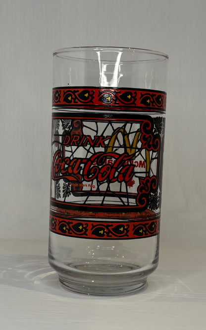 Coca-Cola glass with decorative band on a gray background