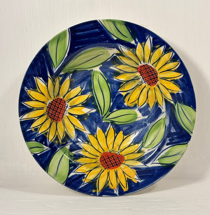 Ceramic bowl with sunflower design on a blue background