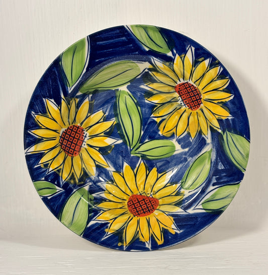 Ceramic bowl with sunflower design on a blue background