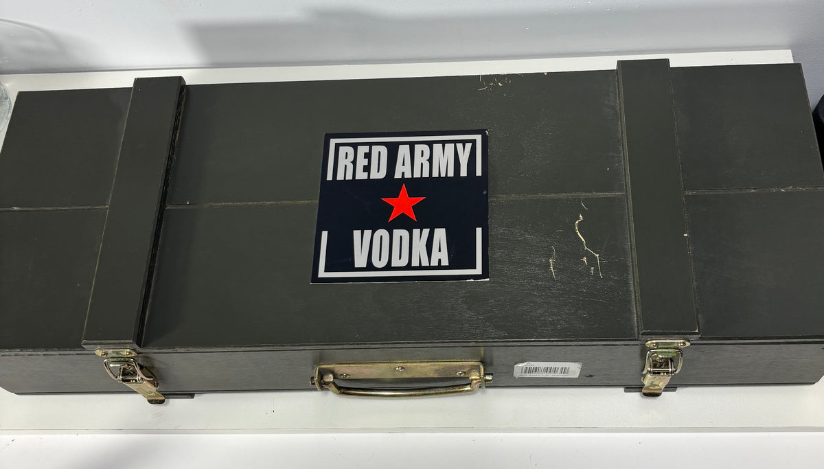 A vintage-style black wooden case with metal latches and a handle, featuring a prominent 'RED ARMY VODKA' label with a red star on the front.