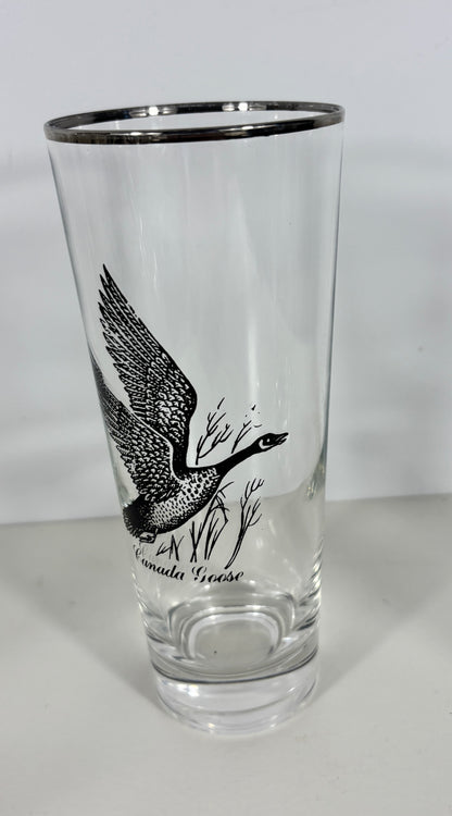 Clear glass with black bird illustration and text on a white background