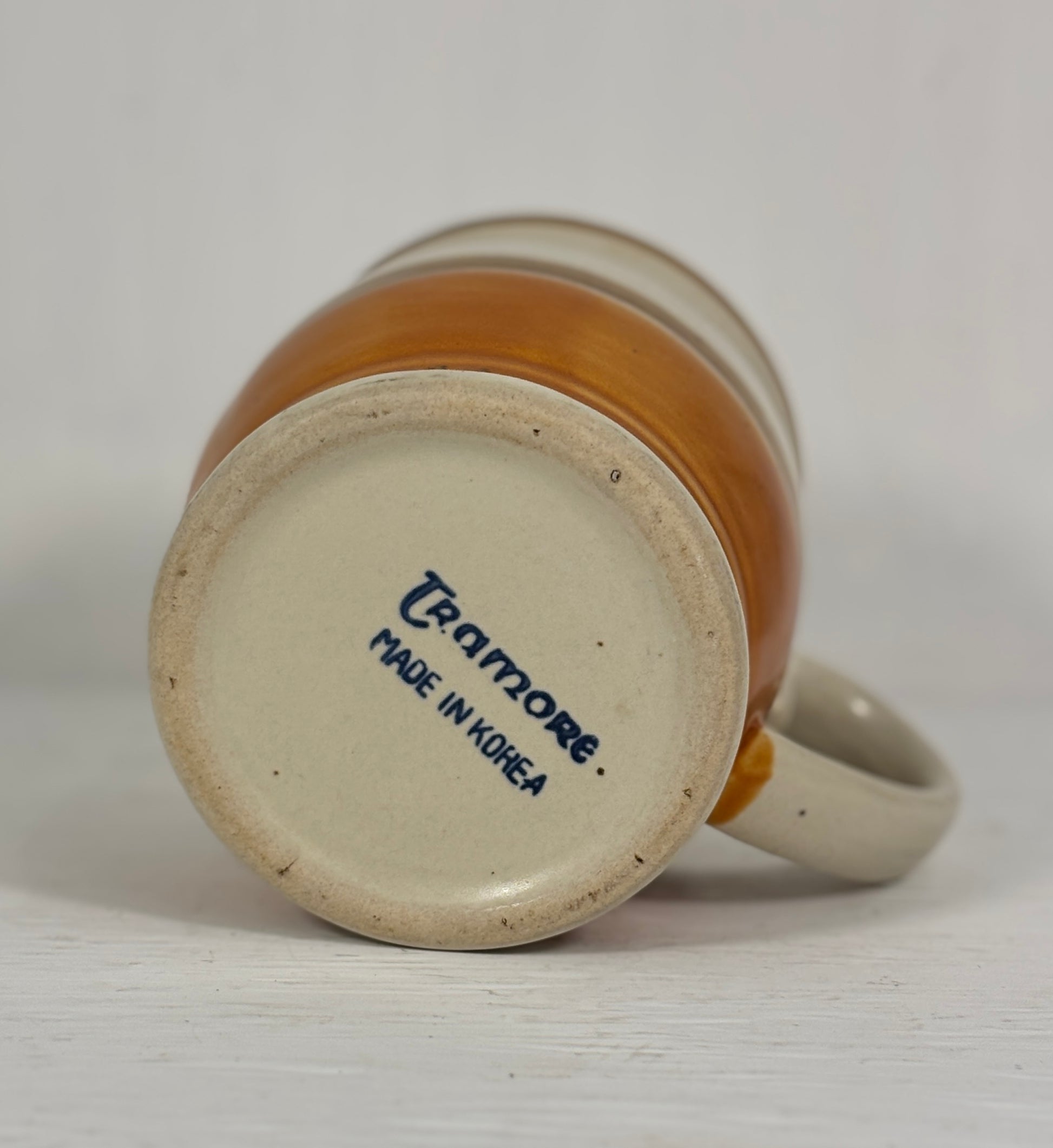 Ceramic mug with 'Cratimore Made in Korea' text on a white background