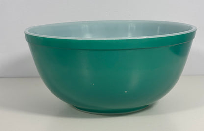 A large teal green mixing bowl with a light blue interior, photographed against a plain white background.