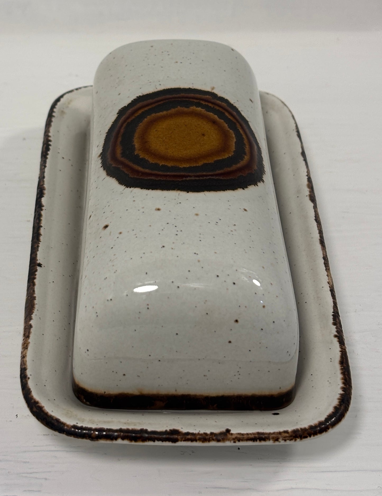 Ceramic butter dish with a brown interior on a white background