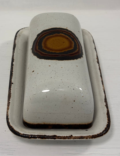 Ceramic butter dish with a brown interior on a white background