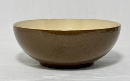 Brown ceramic bowl on a light gray background