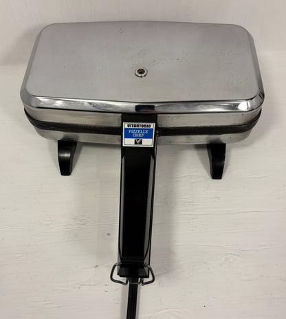 Stainless steel Italian cookie maker on a white background
