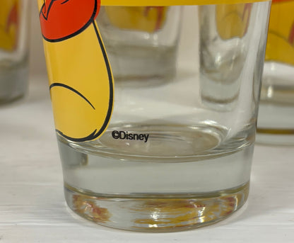 Clear glass with Disney logo and cartoon character on a white surface