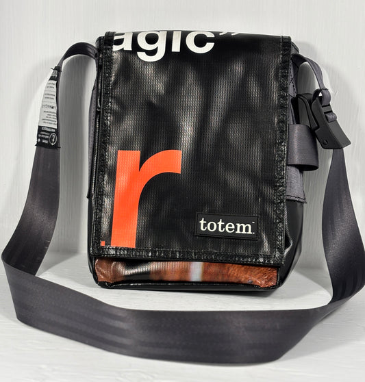 Black shoulder bag with orange 'r' logo and 'totem' branding on a light gray background