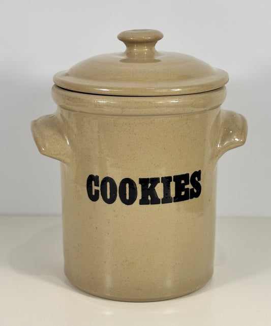Beige ceramic cookie jar with 'COOKIES' text on a white background