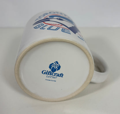 A white ceramic Toronto Blue Jays mug shown upside down, displaying the blue and red team logo on the side and the Giftcraft maker's mark on the bottom base.