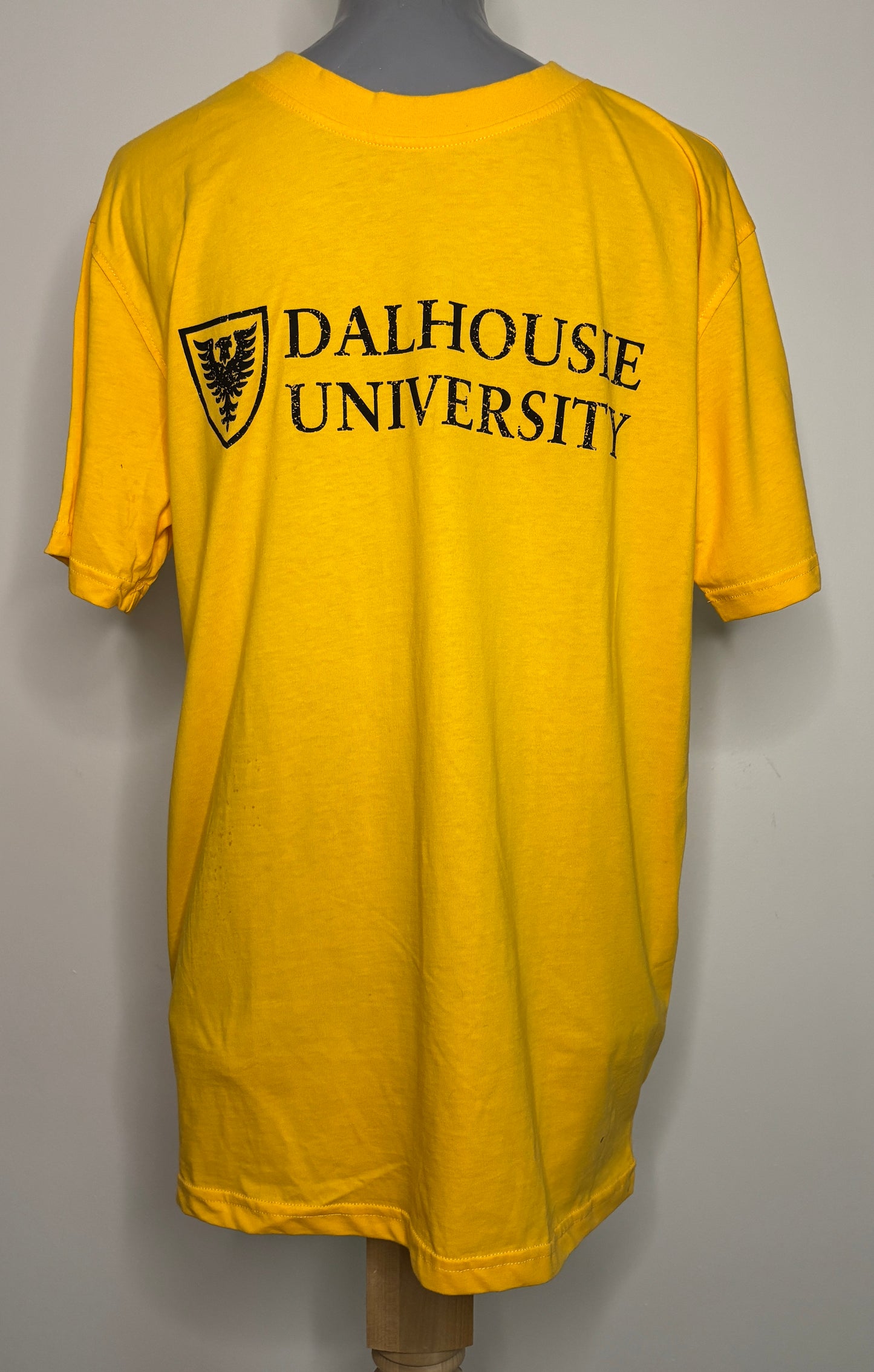 Yellow t-shirt with 'Dalhousie University' text and logo on a gray background