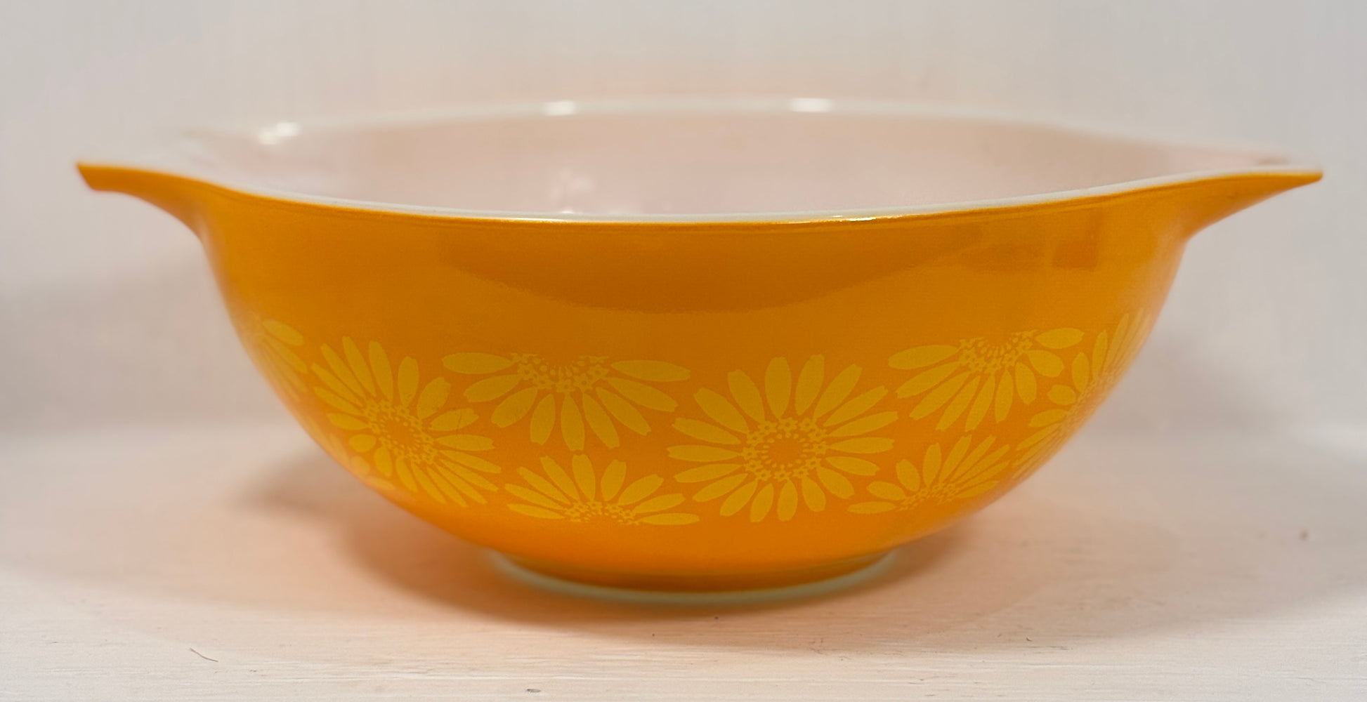 Yellow floral-patterned bowl on a white background