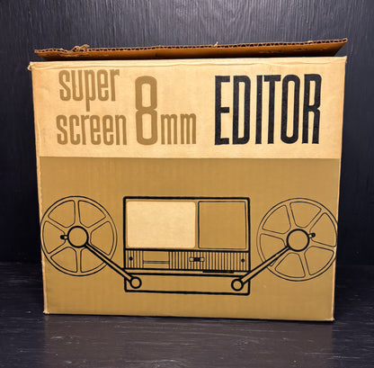 Cardboard box with 'super screen 8mm EDITOR' text and reel-to-reel tape illustration on a black background