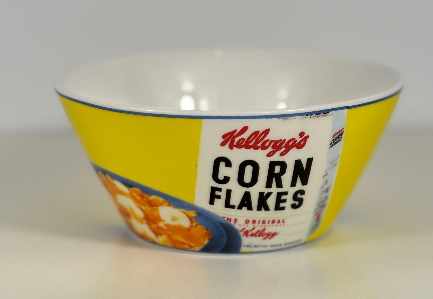 Vintage Kellogg's Corn Flakes bowl with yellow and white design on a white background