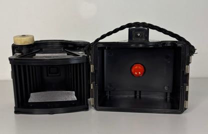 Black box camera with open lid on a white background