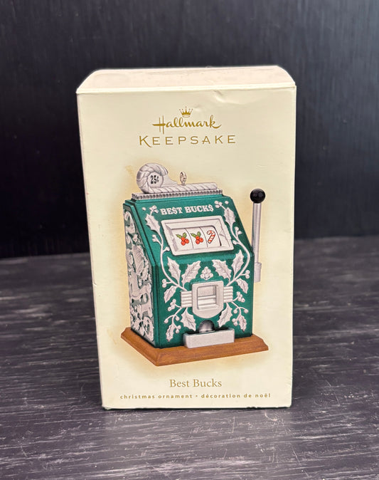 Hallmark Keepsake Christmas ornament packaging with slot machine design on a dark surface.