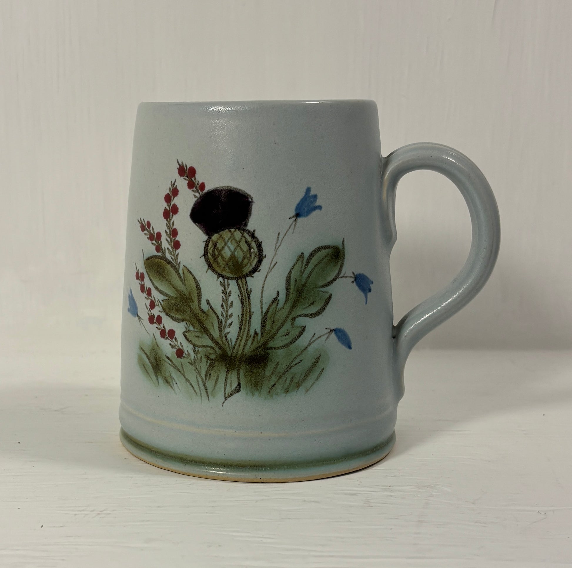 Ceramic mug with floral design on a white background