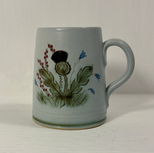 Ceramic mug with floral design on a white background