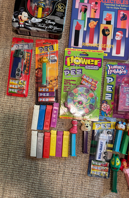 Collection of Pez dispensers and related items on a textured surface