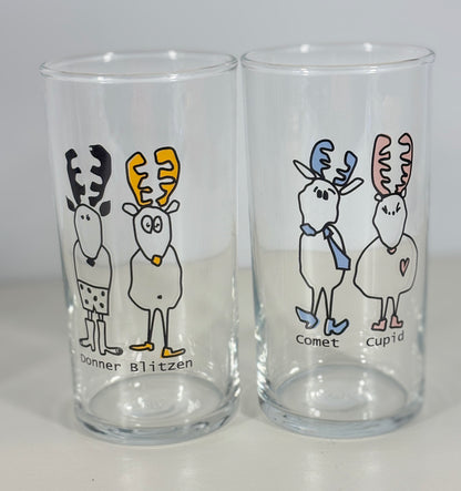 Two clear glasses with cartoon reindeer designs on a gray background