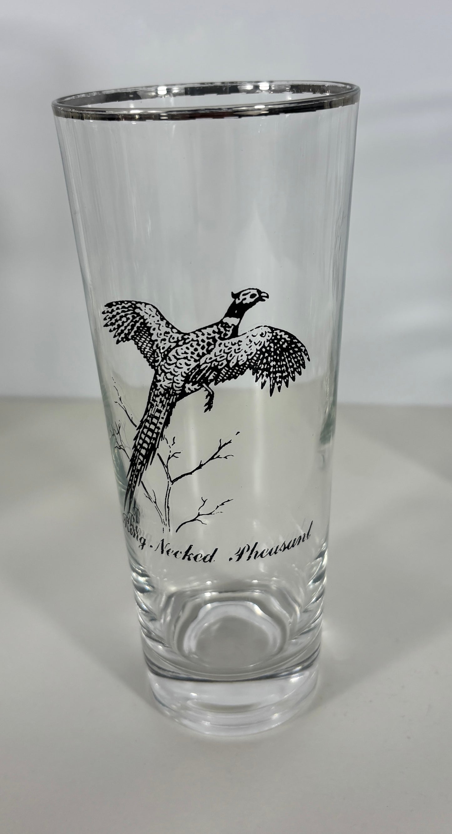 Clear glass with a black bird illustration and text on a white background