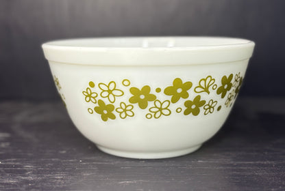 White bowl with gold floral pattern on a dark surface