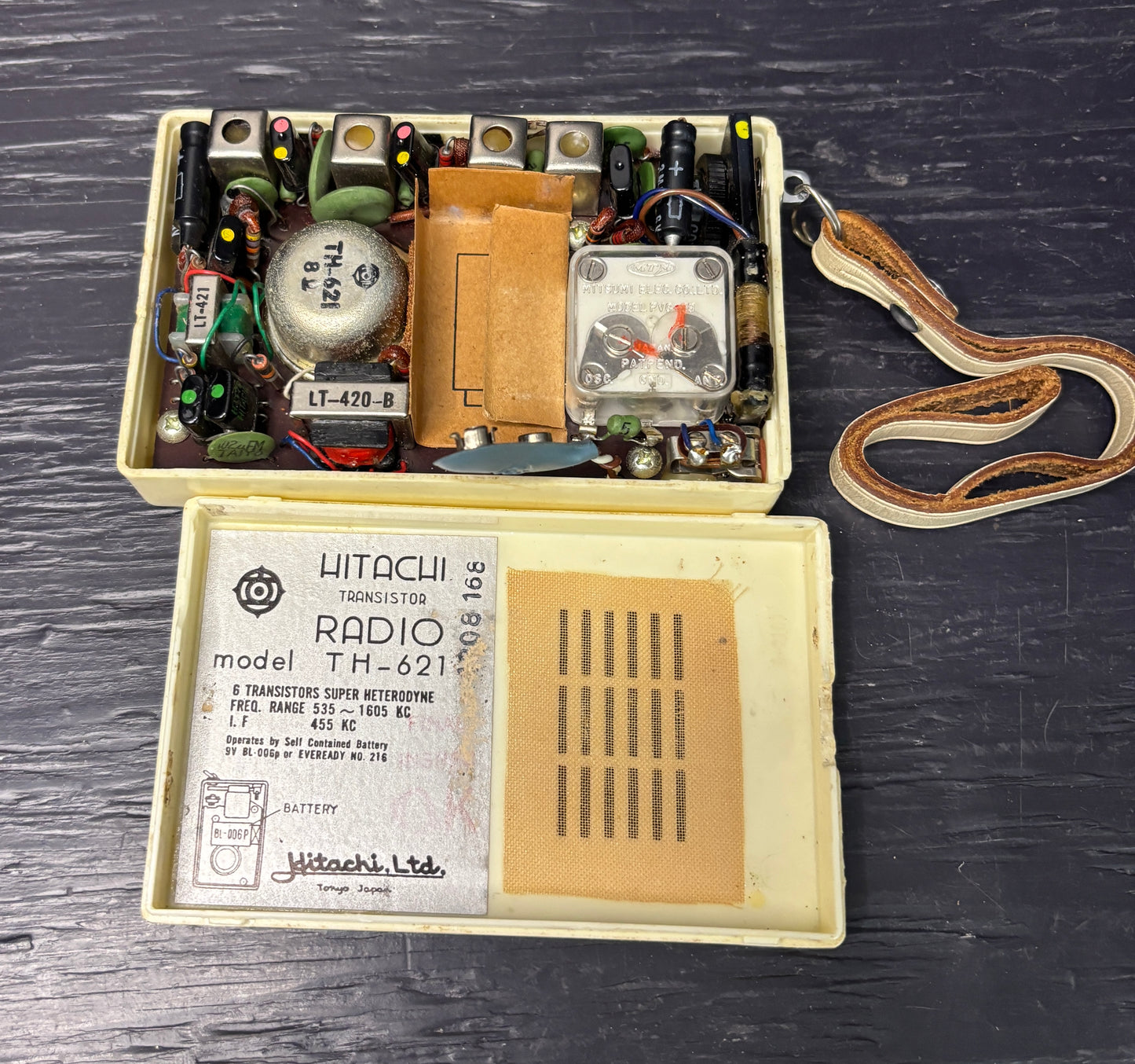 Vintage Hitachi radio model TH-621 with electronic components on a dark wooden surface